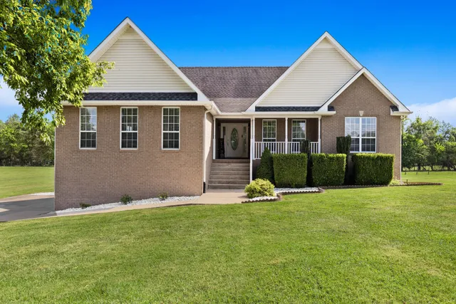 a front view of a house with a yard and garage