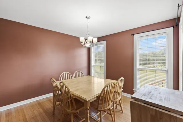 a view of a dining room with furniture and window
