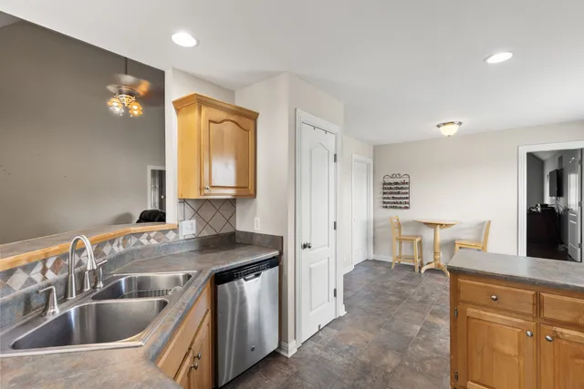a kitchen that has a sink and a large window in it