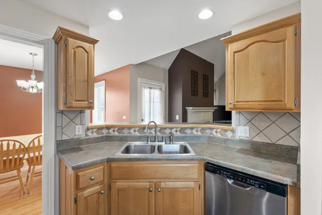 a bathroom with a granite countertop sink a mirror and a shower