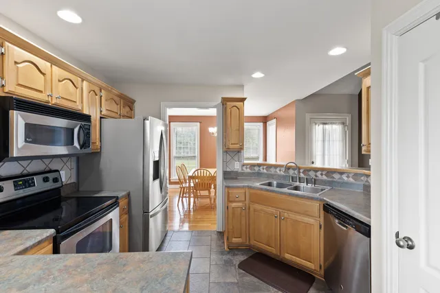 a kitchen with stainless steel appliances granite countertop a stove and a refrigerator