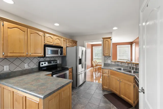 a kitchen with a stove a sink and a refrigerator