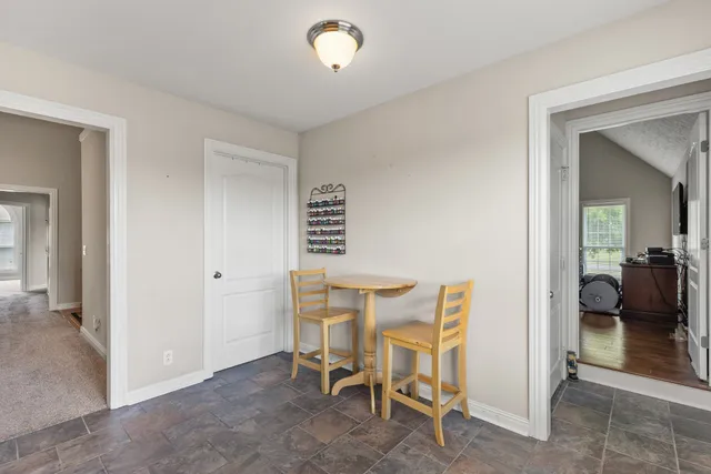 a view of a room with chairs and a table