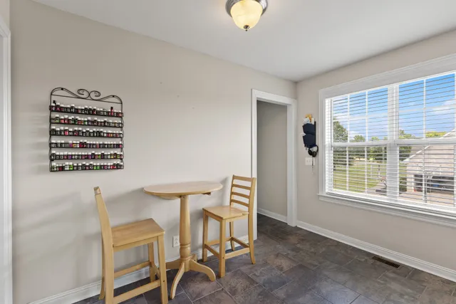 a view of a workspace with furniture and a window