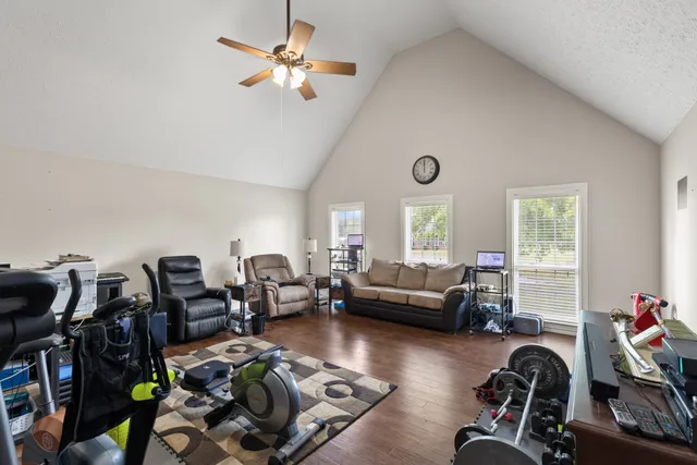 a living room with furniture gym equipment and a window