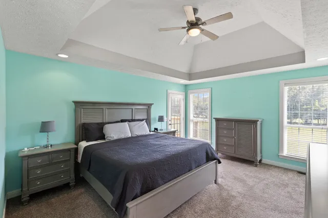 a bedroom with a bed and a ceiling fan