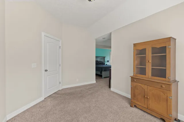 an empty room with windows and cabinet