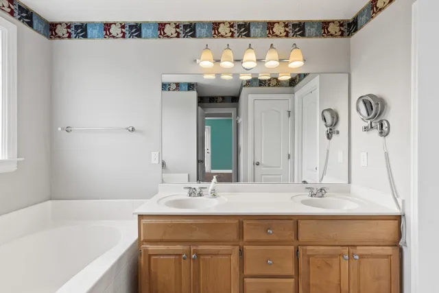 a bathroom with a sink vanity and a mirror