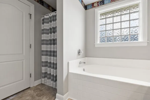 a bathroom with a bathtub and shower
