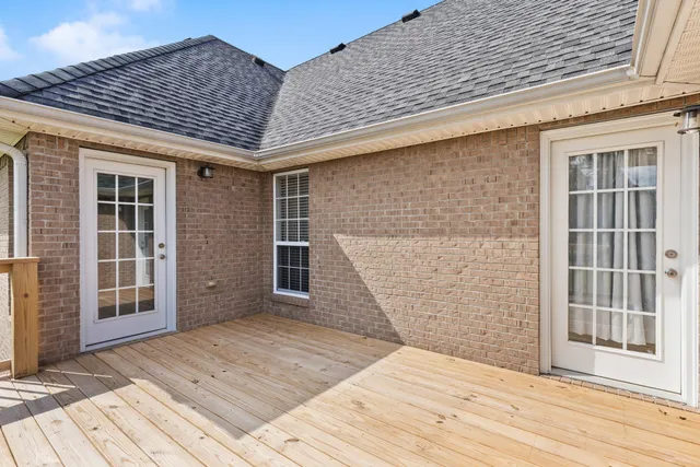 a backyard of a house with wooden floor