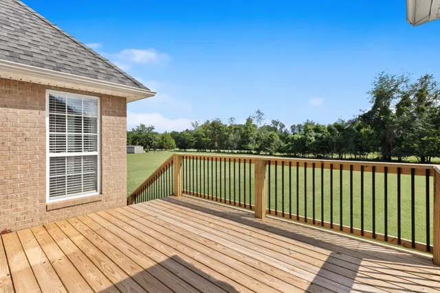 a view of balcony with wooden floor and fence