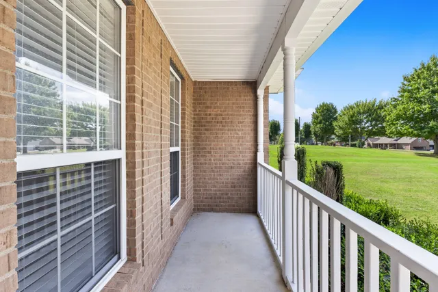 a view of balcony with yard