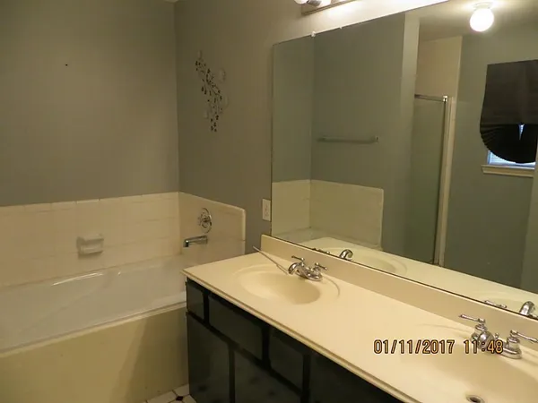 a bathroom with a bathtub and shower