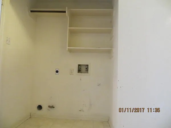 an empty room with wooden floor and closet