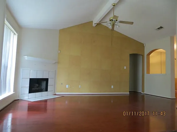 a view of an empty room and fire place