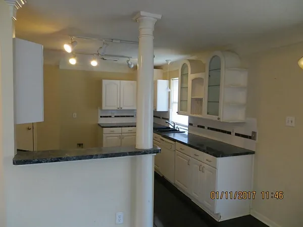 a kitchen with a sink and cabinets