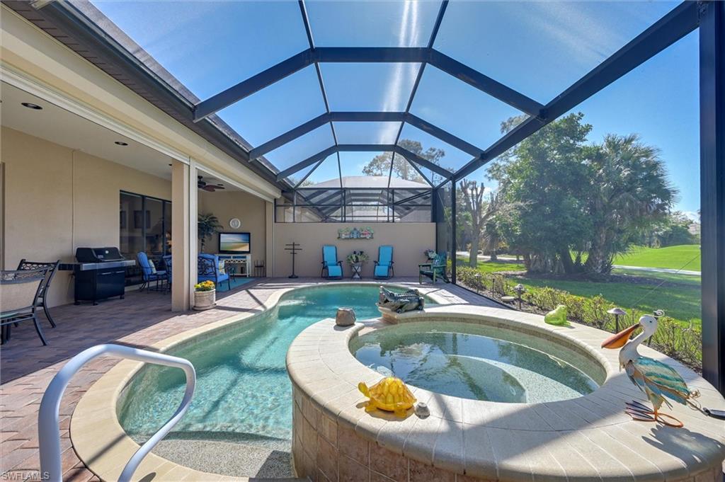 7587 Moorgate Point Way Naples, FL 34113 - Photo 12 of 50 Screened outdoor living area with a contoured swimming pool and integrated spa