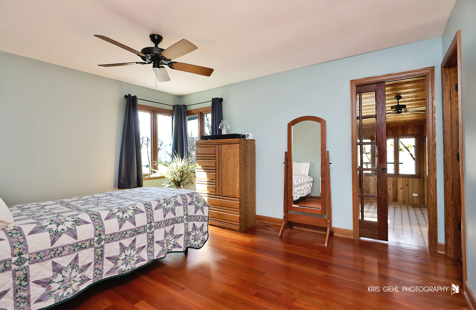 7149 Meadow Lane Cary, IL 60013 - Photo 13 of 37 a bedroom with a large bed and a chandelier