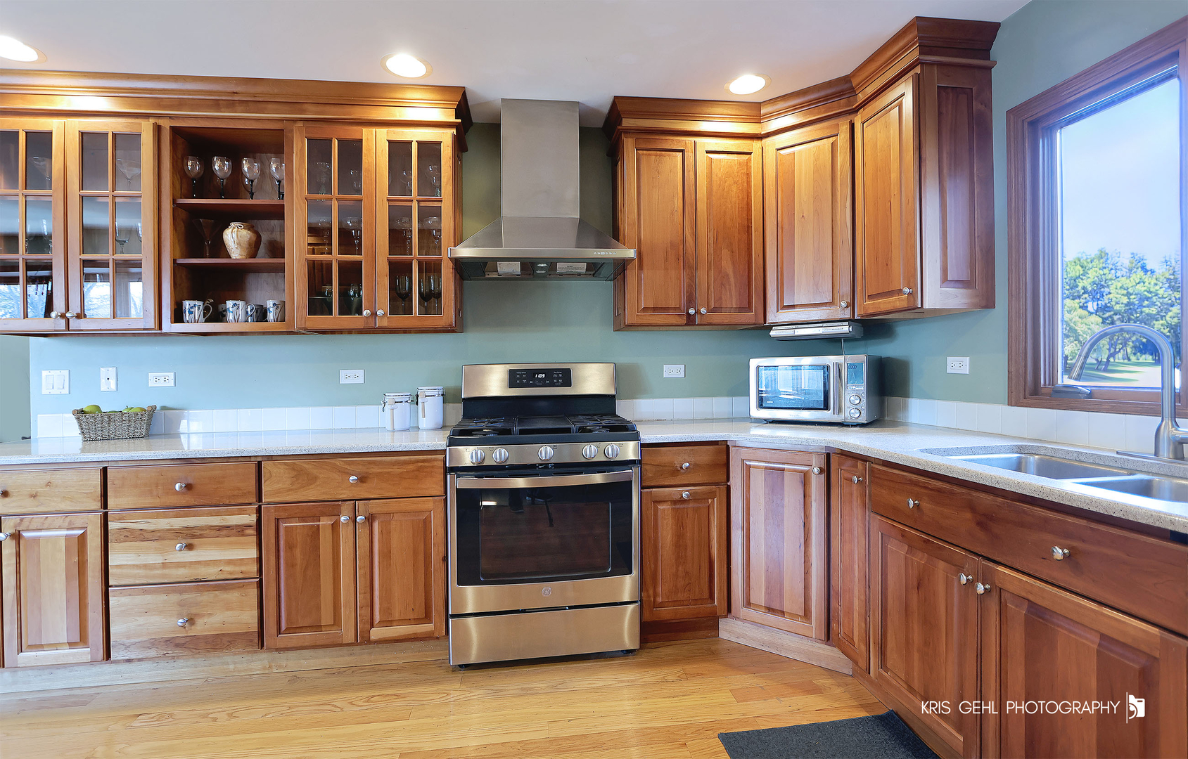 7149 Meadow Lane Cary, IL 60013 - Photo 9 of 37 a kitchen with stainless steel appliances granite countertop a stove a sink and a microwave