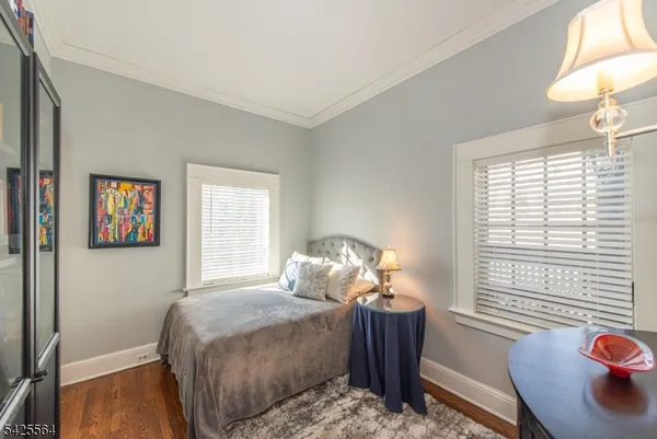 a spacious bedroom with a bed and a chandelier