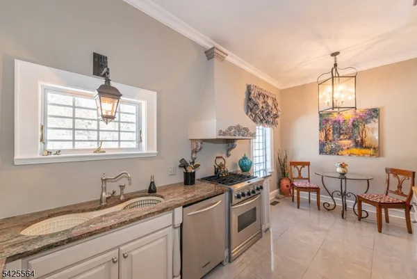 a kitchen with stainless steel appliances granite countertop a sink stove and cabinets