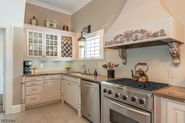 a kitchen with stainless steel appliances a stove a table and chairs