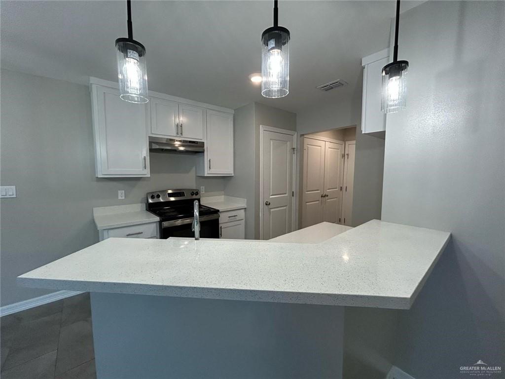 2222 Multi National, Unit C Harlingen, TX 78550 - Photo 6 of 7 a kitchen with stainless steel appliances a kitchen island a sink dishwasher a refrigerator and microwave