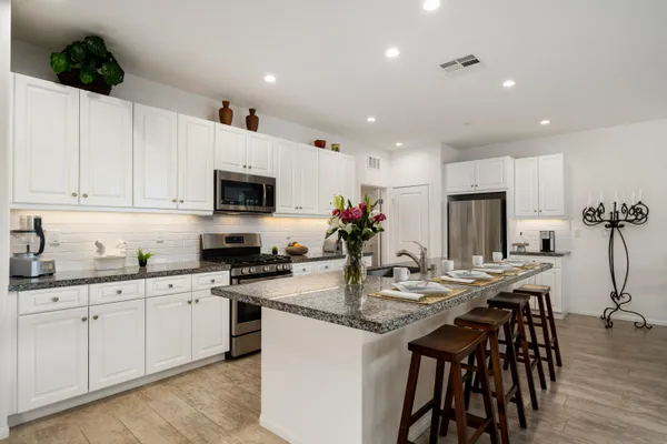 a kitchen with sink a microwave and cabinets