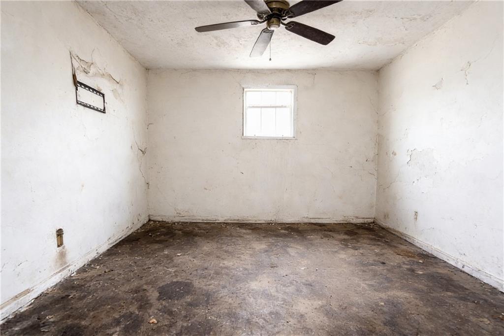 731 Bolton Road Northwest Atlanta, GA 30331 - Photo 13 of 20 an empty room with a window and a fan