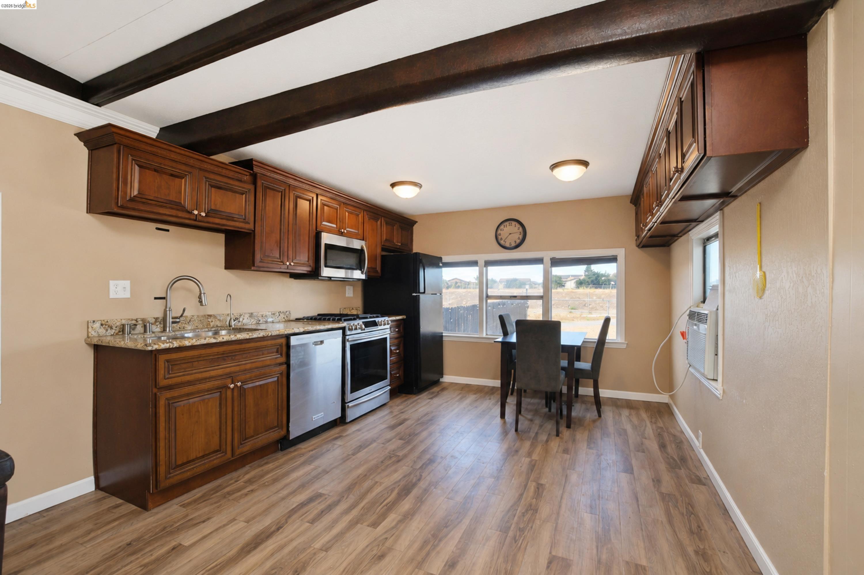 340 West Bolton Road Oakley, CA 94561 - Photo 78 of 87 Kitchen featuring wood-finish flooring, exposed ceiling beams, stainless steel appliances, granite-style countertops, and wood cabinetry