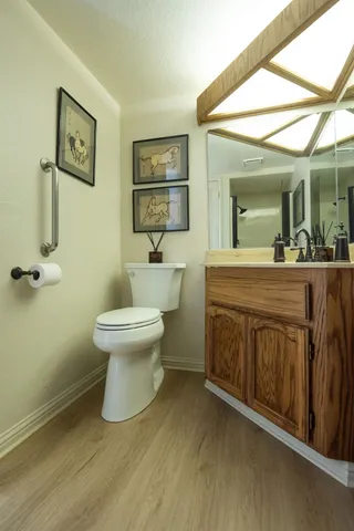 a bathroom with a toilet sink and mirror