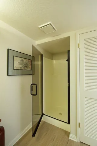 a view of a hallway with wooden floor