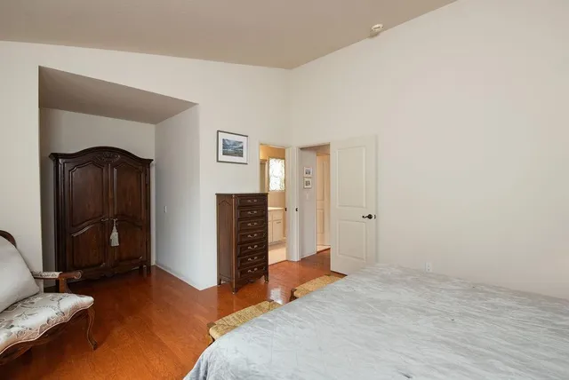 a bedroom with a bed and a mirror