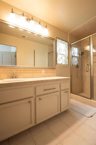 a bathroom with a sink a mirror and a shower