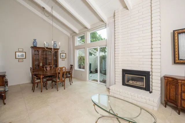 a dining room with furniture fireplace and a window