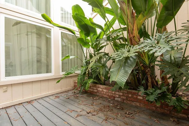 a backyard of a house with table and chairs