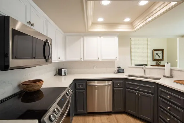 a kitchen with a sink a stove and cabinets