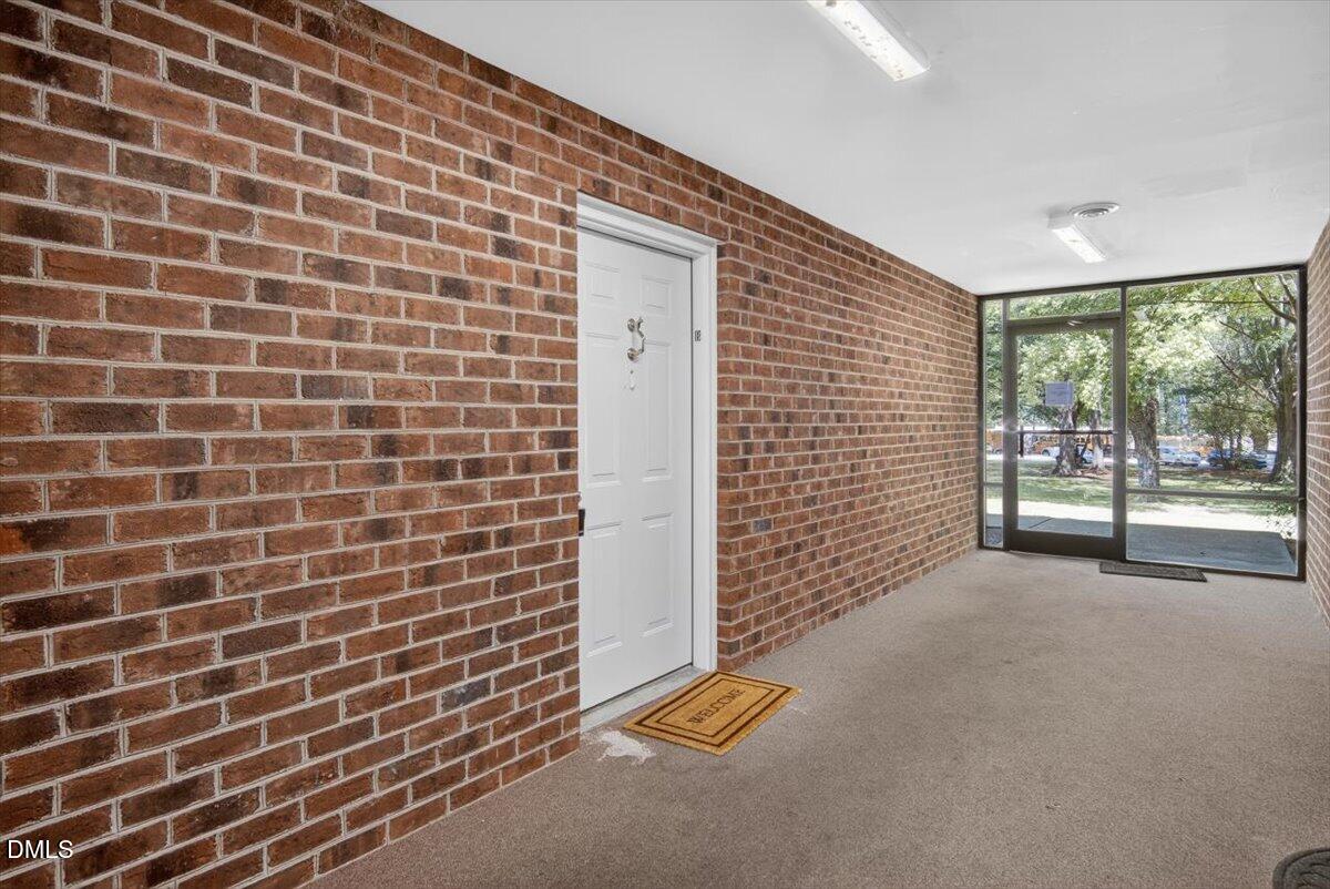 1630 Oxford Road, Unit B Henderson, NC 27536 - Photo 22 of 30 a view of a brick wall with a building in the background