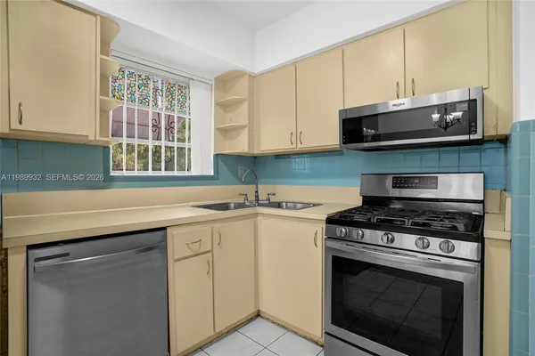 a view of a park with a bench and trees