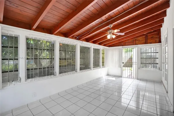 a view of a house with swimming pool and porch with furniture
