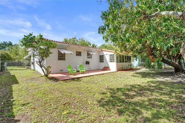 a open kitchen with stainless steel appliances granite countertop a refrigerator a oven a white stove a sink and a refrigerator with wooden floor