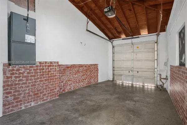 a kitchen with sink a microwave and refrigerator