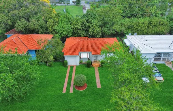 an empty room with wooden floor closet and windows