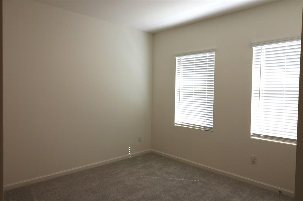 1301 Elliott Road Howe, TX 75459 - Photo 14 of 27 Neutral wall finishes, two windows with blinds, and carpeted flooring