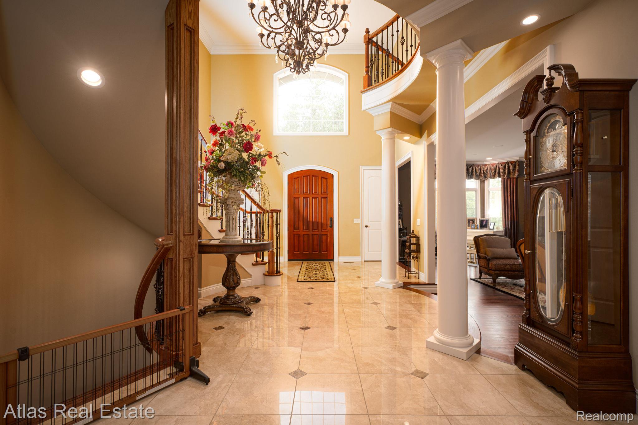10380 South State Road Goodrich, MI 48438 - Photo 24 of 87 Grand foyer featuring a two-story ceiling and a curved staircase with wood-finish railing