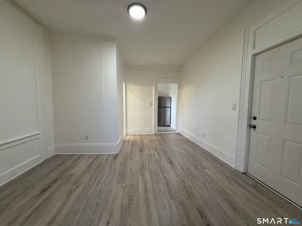 a view of a room with wooden floor and window
