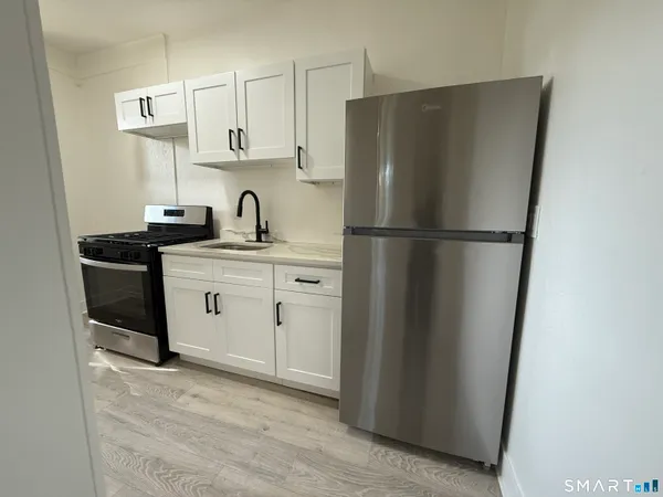 a white refrigerator freezer sitting in a kitchen