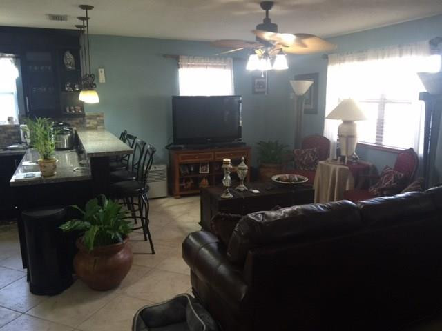 35 Tortuga Road Palm Springs, FL 33461 - Photo 3 of 17 a living room with furniture and a chandelier