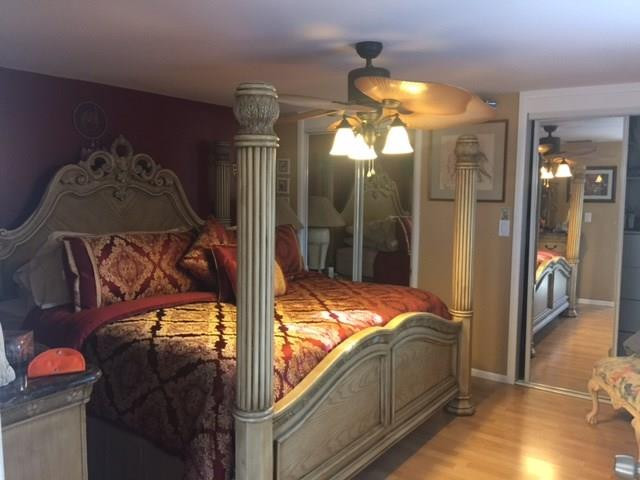 35 Tortuga Road Palm Springs, FL 33461 - Photo 10 of 17 a bedroom with a bed and a mirror