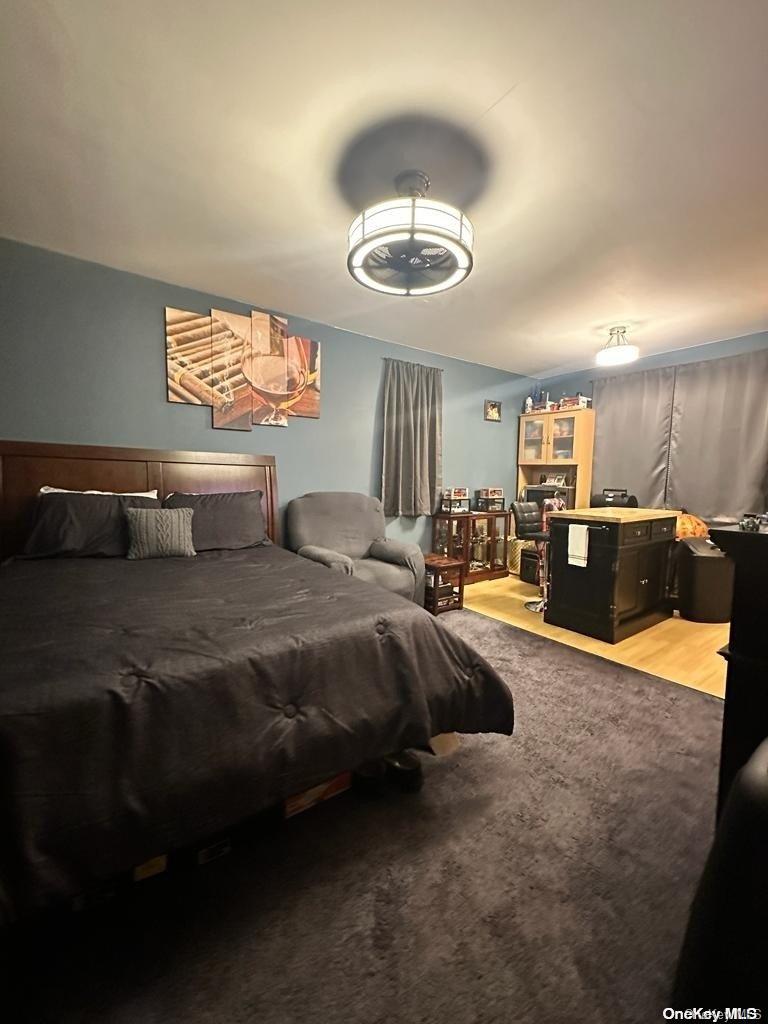 36 Cathedral Avenue, Unit 3C Hempstead, NY 11550 - Photo 1 of 1 a spacious bedroom with a bed and a chandelier